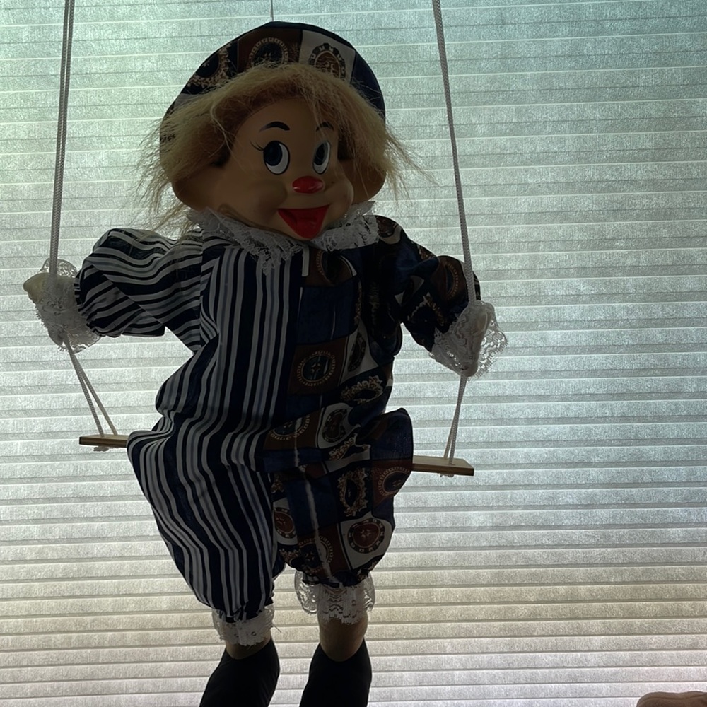 Puppet clown on swinging chair. Vintage.Swings with a string attached to finger.